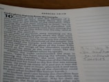 A close-up view of a page from a book with a passage from Ezekiel 10:1-19. The text is black and aligns in justified margins on an off-white background. On the right side, there is a lined margin with some handwritten notes in blue ink.