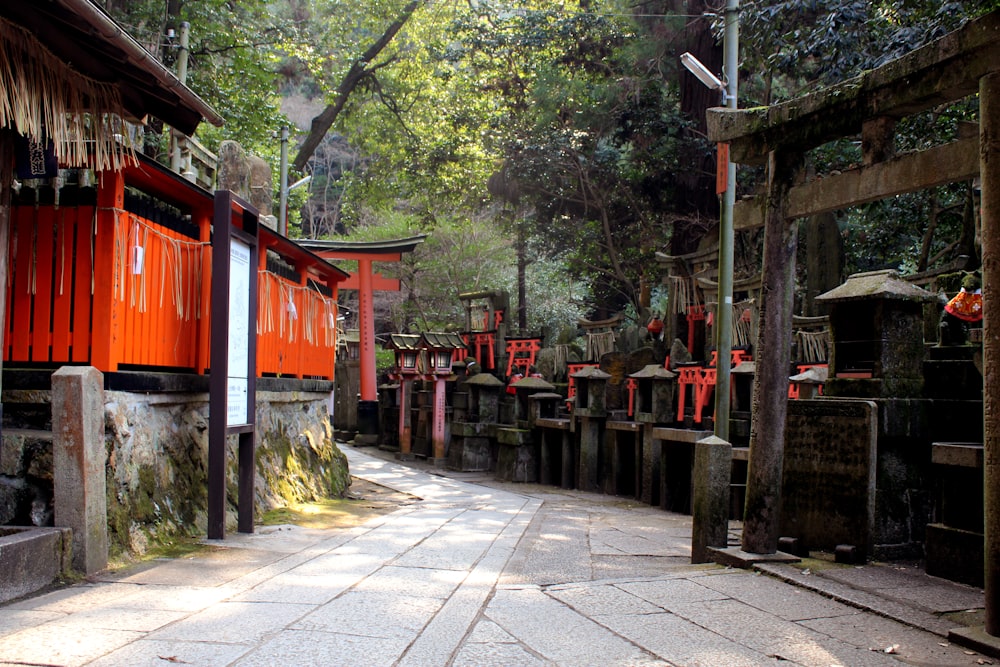 a narrow street lined with red wooden buildings