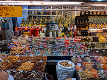 A vibrant display of various spices and mustard oil products.