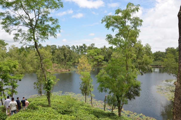 A serene river landscape with families enjoying nature.
