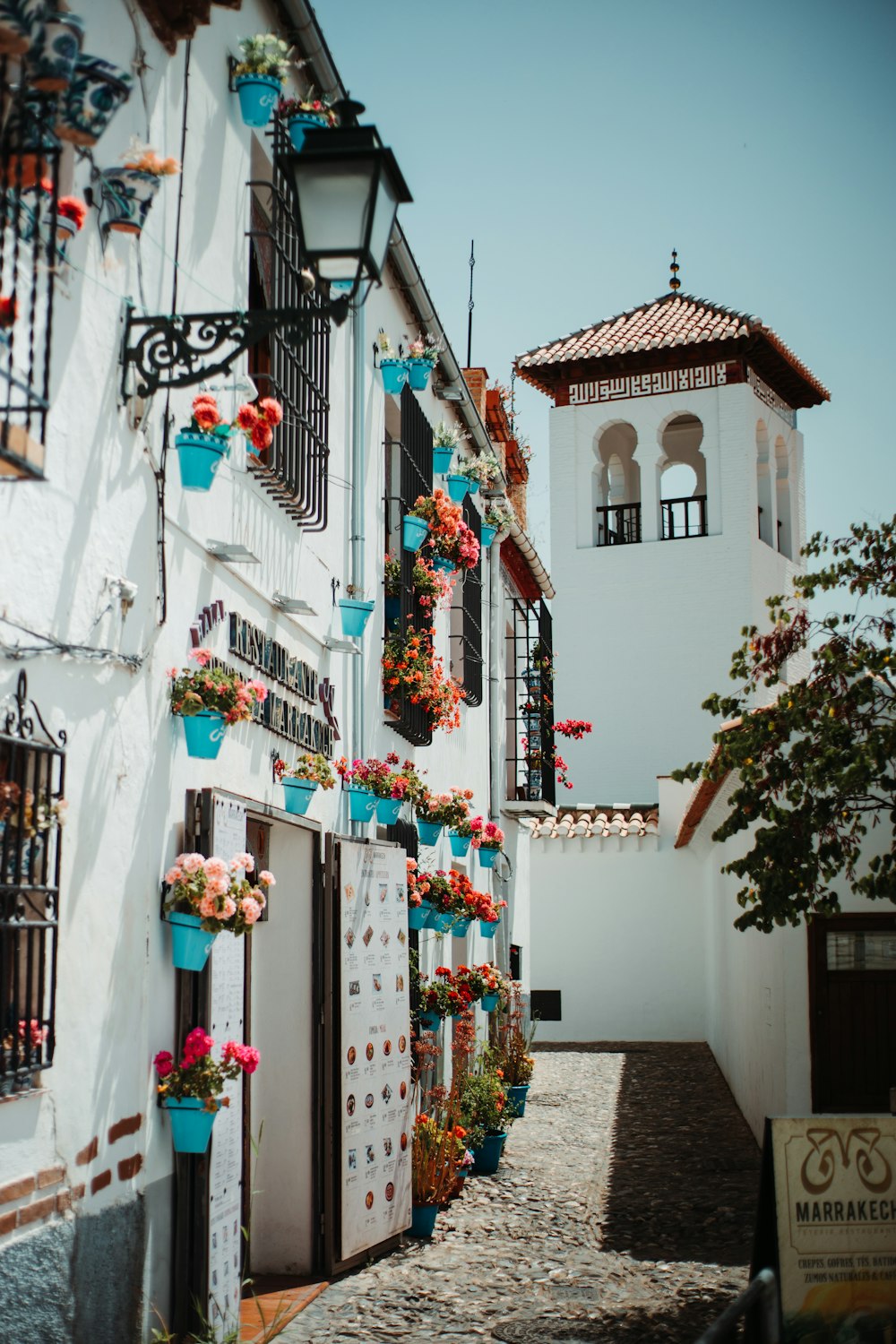 a white building with a bunch of flowers on it