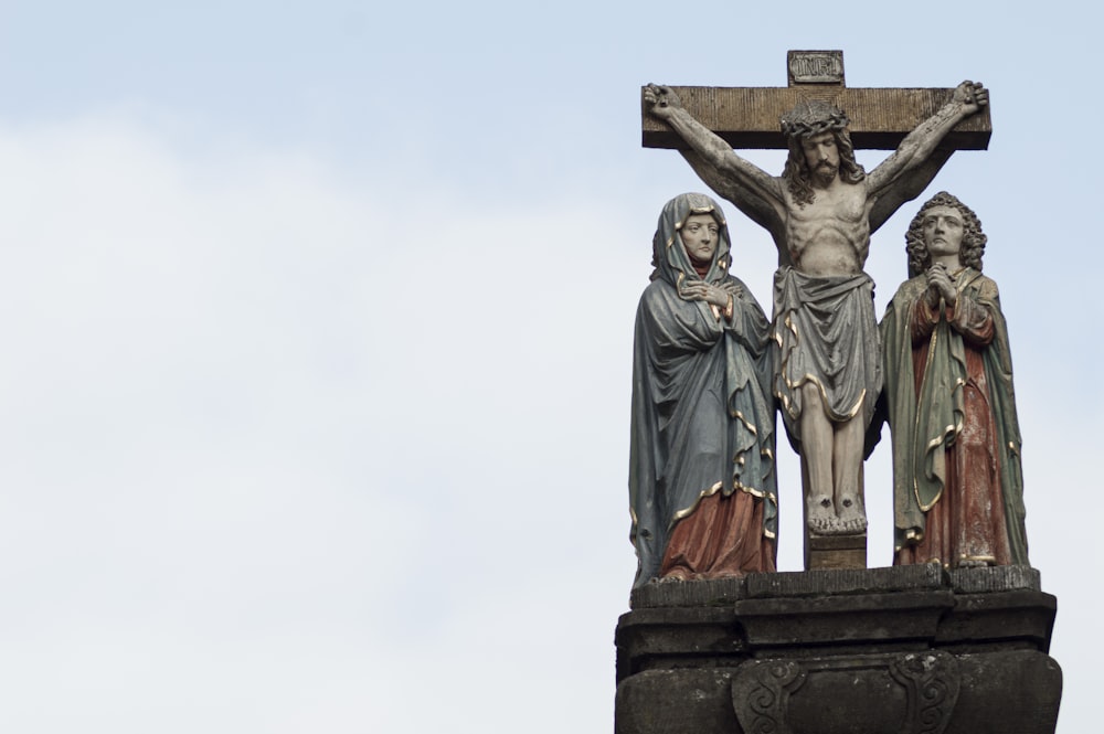 a statue of jesus on the cross with two other statues