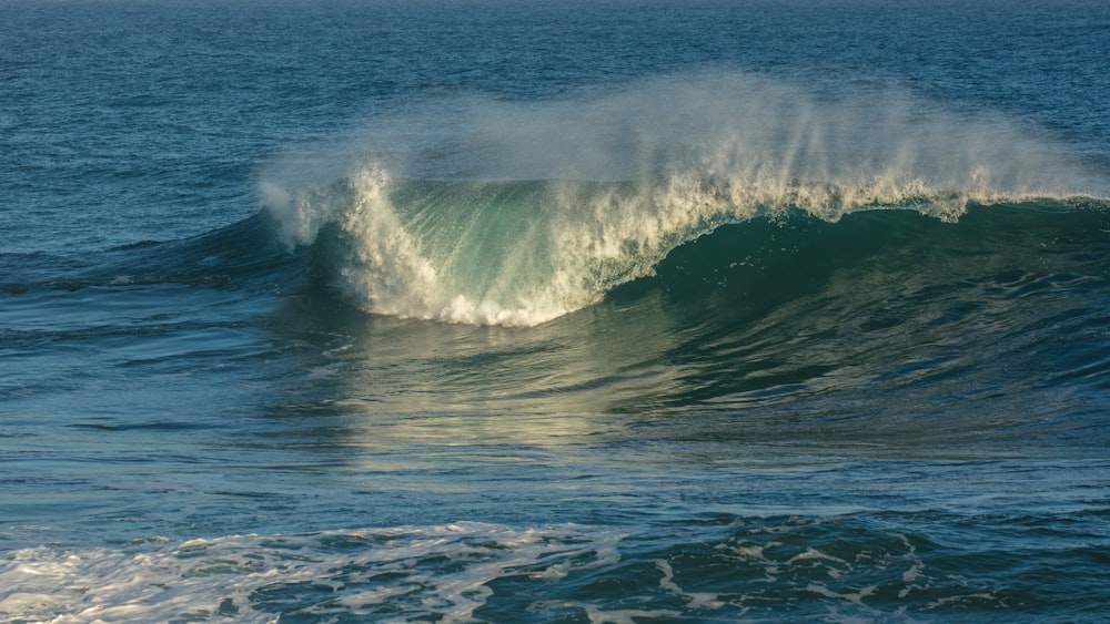 a person riding a wave on top of a surfboard