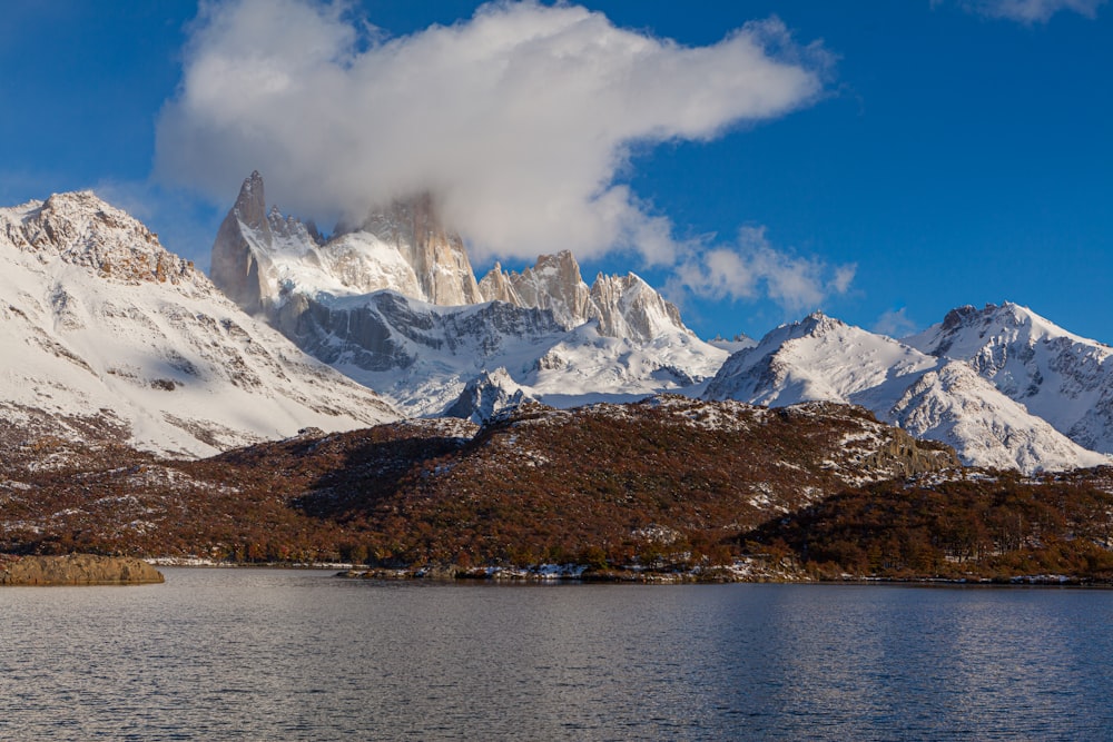 a mountain range covered in snow and clouds