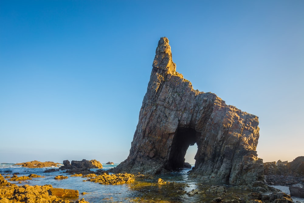 a large rock sticking out of the ocean