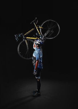 A friendly staff member holding a bicycle ready for service at Velo Hotel.