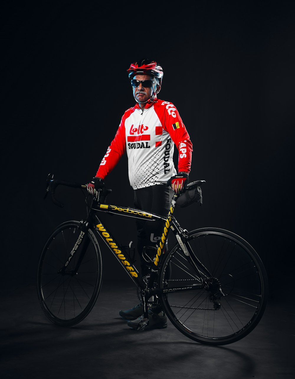 a man standing next to a bike wearing a helmet