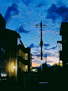 Modern concentrator device installed on a utility pole with a background of a city skyline at dusk.