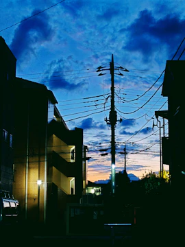 Modern concentrator device installed on a utility pole with a background of a city skyline at dusk.