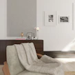 Close-up of elegant home essentials like minimalist lamps and cozy throws in a warm setting