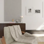 Close-up of elegant home essentials like minimalist lamps and cozy throws in a warm setting