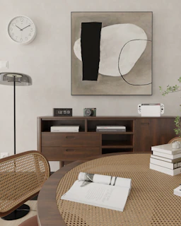 a picture of a table with books and a clock on the wall