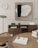 A modern interior scene featuring a wooden dining table with a woven rattan chair and a round clock on the wall. A sleek, minimalistic art piece hangs above a wooden sideboard, which holds a digital clock, camera, and a gaming console. Books are stacked on the sideboard and table, and a small plant adds a touch of greenery.