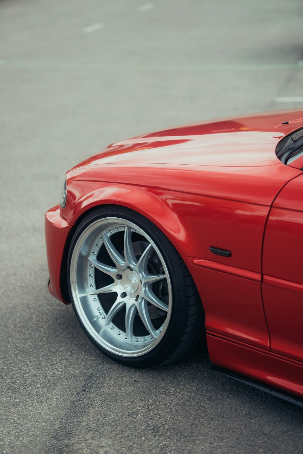 a red sports car parked in a parking lot