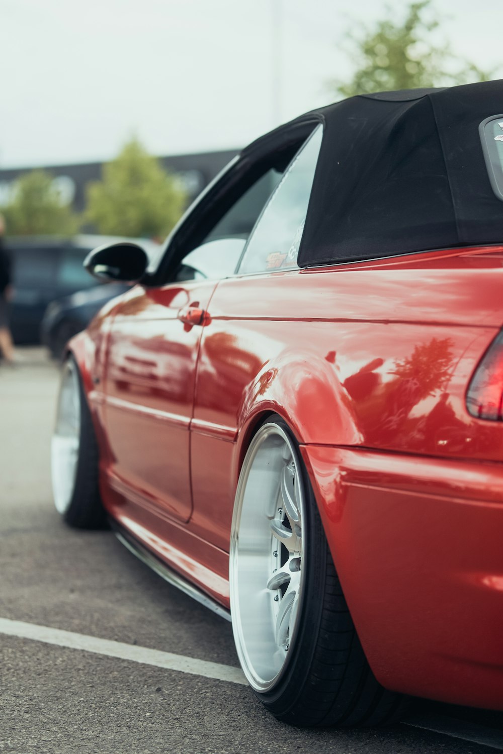 a red sports car parked in a parking lot