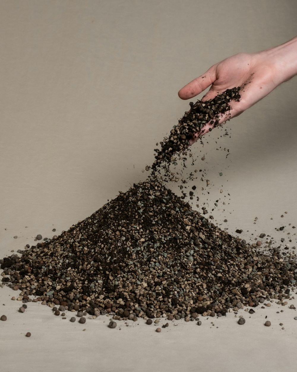 a pile of dirt in a person's hand
