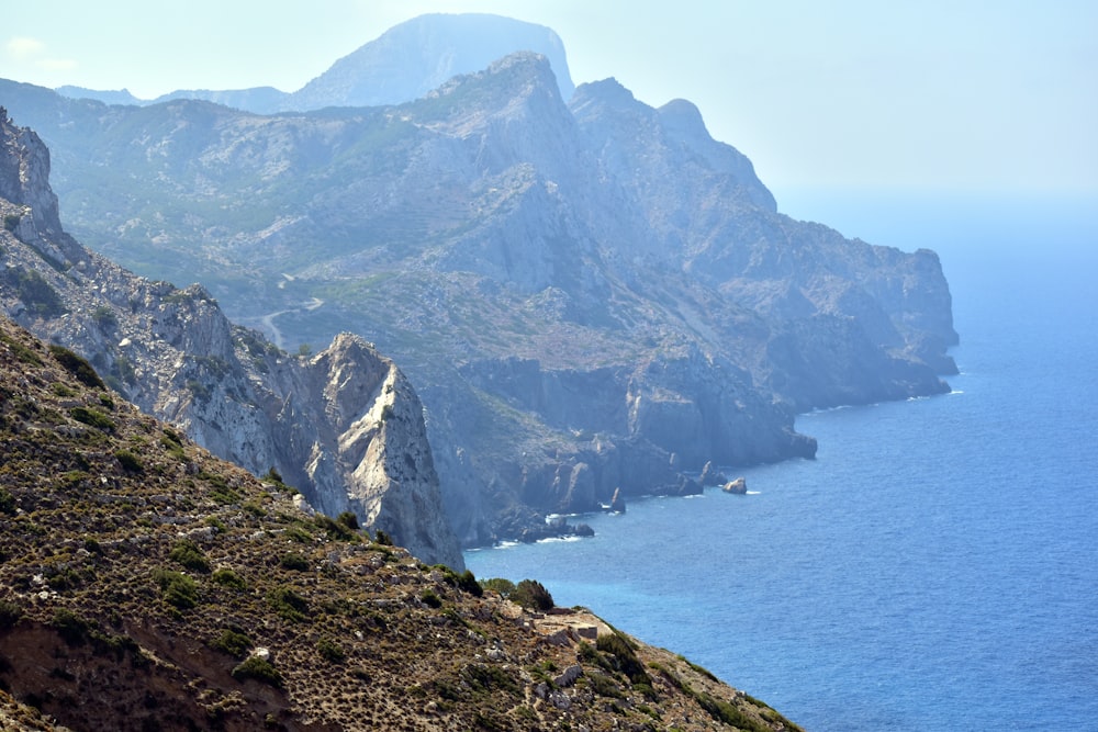 a view of a mountain with a body of water in the background