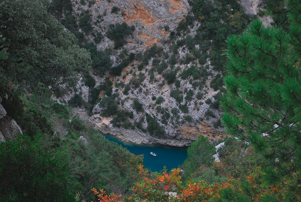 a lake surrounded by trees and a cliff