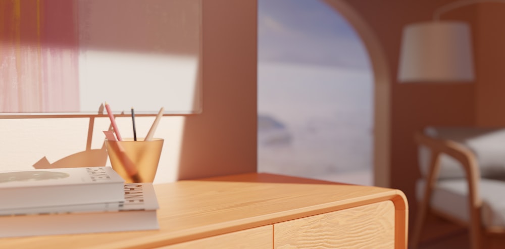 a desk with a book, pen and pencil holder on it