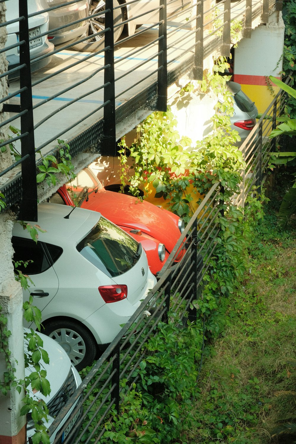 a white car parked next to a fence