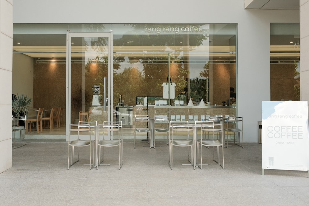 a group of chairs sitting outside of a coffee shop