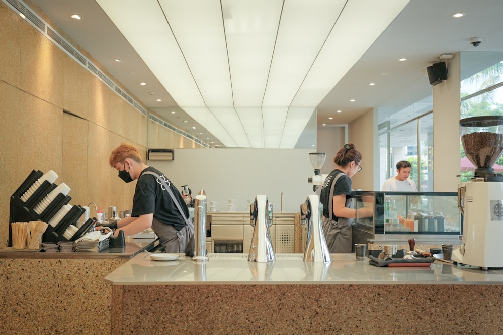 a couple of people that are standing at a counter