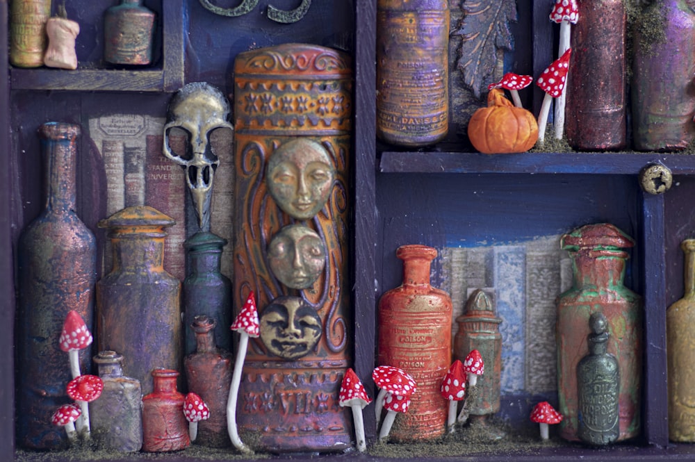 a shelf filled with lots of different colored vases