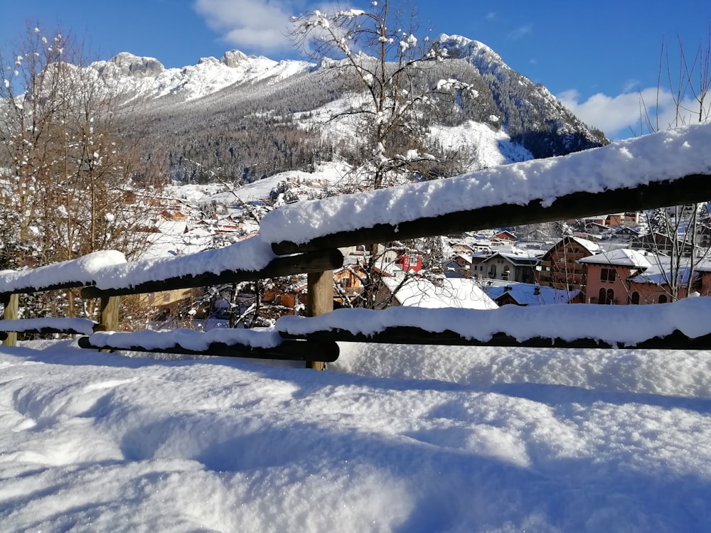 a view of a snow covered mountain from a bench
