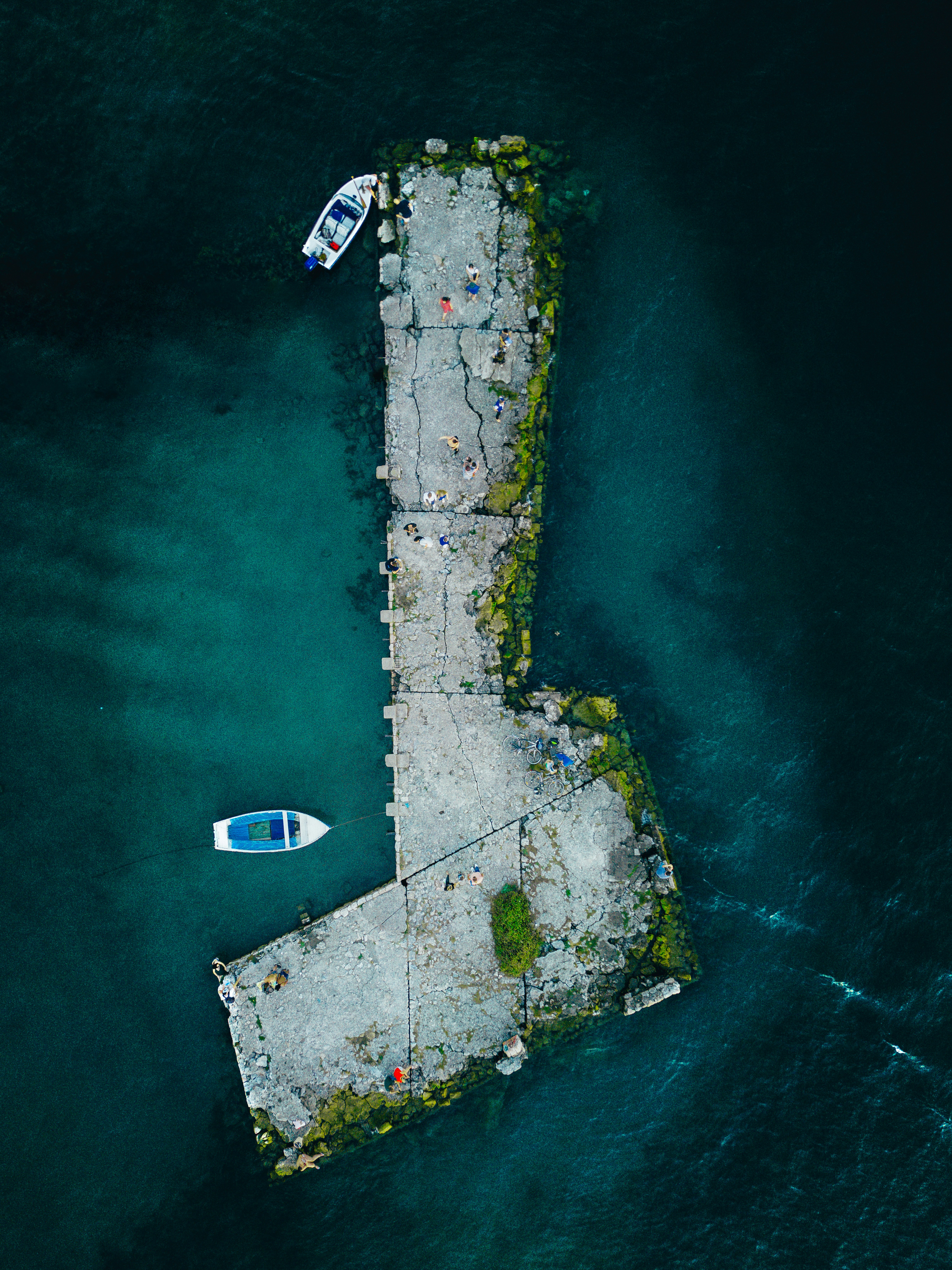 an aerial view of a pier with two boats