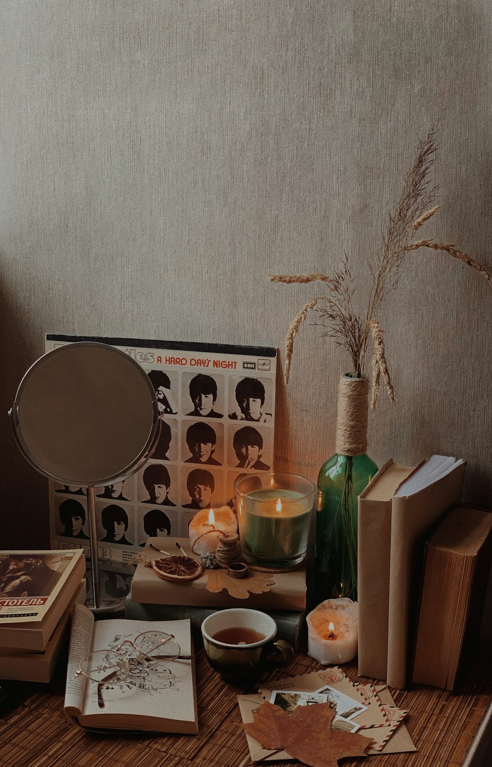 a wooden table topped with books and candles