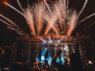 a crowd of people watching fireworks on a stage