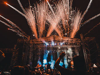 a crowd of people watching fireworks on a stage