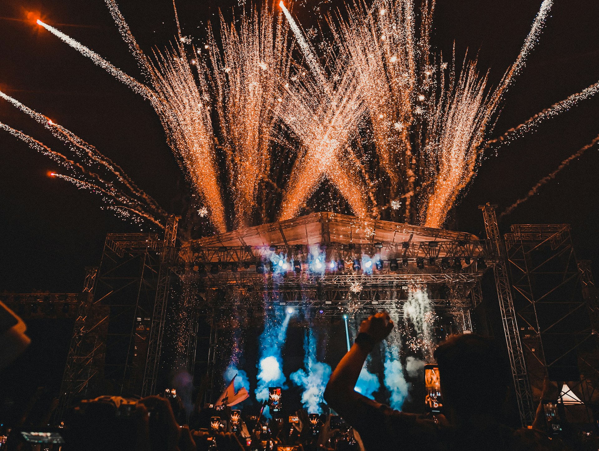 a crowd of people watching fireworks on a stage