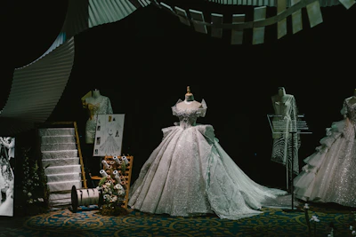 Elegant display of women’s fashion outfits featuring flowing silhouettes and rich textures in a modern setting