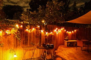 a wooden fence with lights hanging from it
