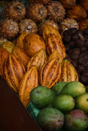 Colorful assortment of tropical fruits displayed on a rustic wooden table