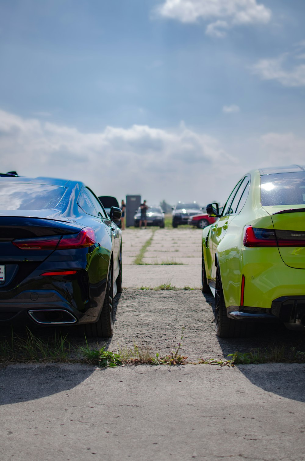 two cars parked next to each other in a parking lot