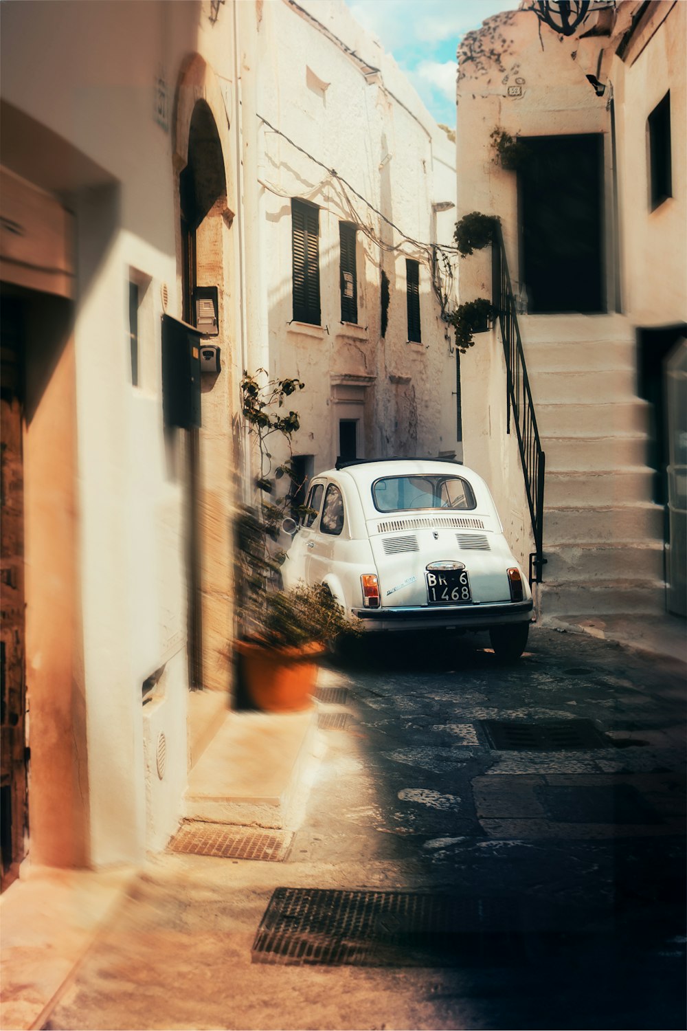 a car parked on the side of a street next to a building