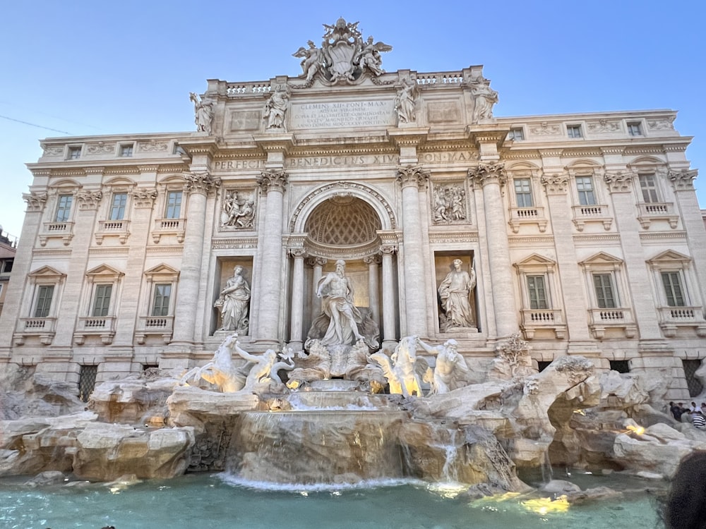 a large building with a fountain in front of it