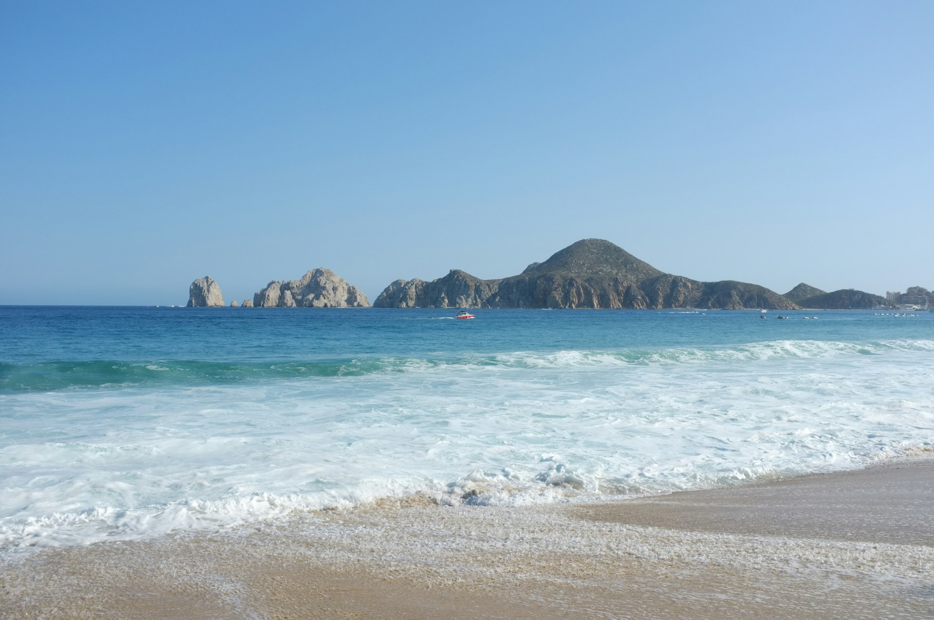 a view of a beach with mountains in the background