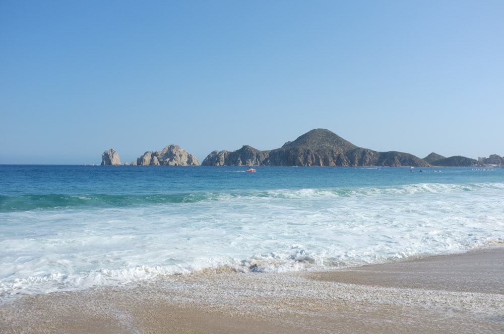 a view of a beach with mountains in the background