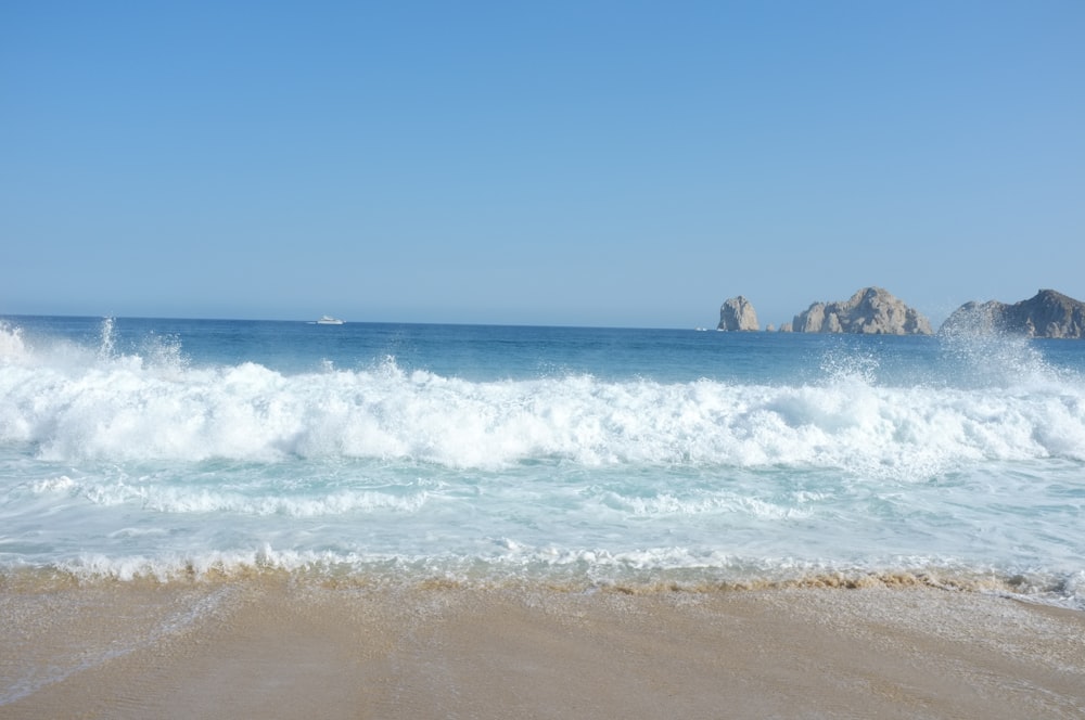 a beach with waves crashing in to shore