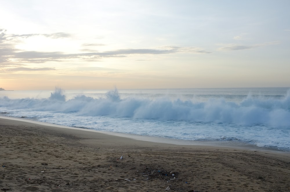 a beach with waves crashing on the shore