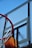 Close-up of a sturdy basketball net with a clear blue sky in the background