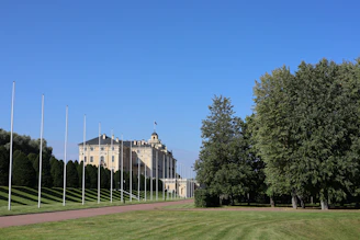 A well-maintained government building surrounded by neatly trimmed landscaping.