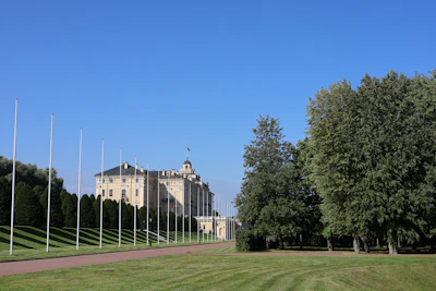 A well-maintained government building surrounded by neatly trimmed landscaping.