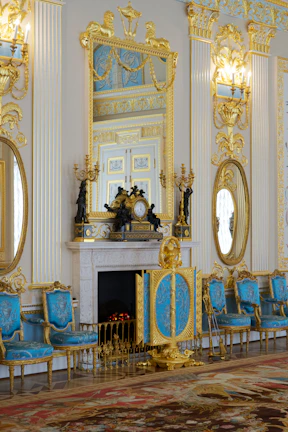 Spacious elegant living room with blue and gold decor reflecting luxury