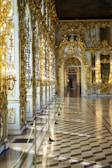 Sophisticated hallway featuring gold-trimmed details and subtle lighting.