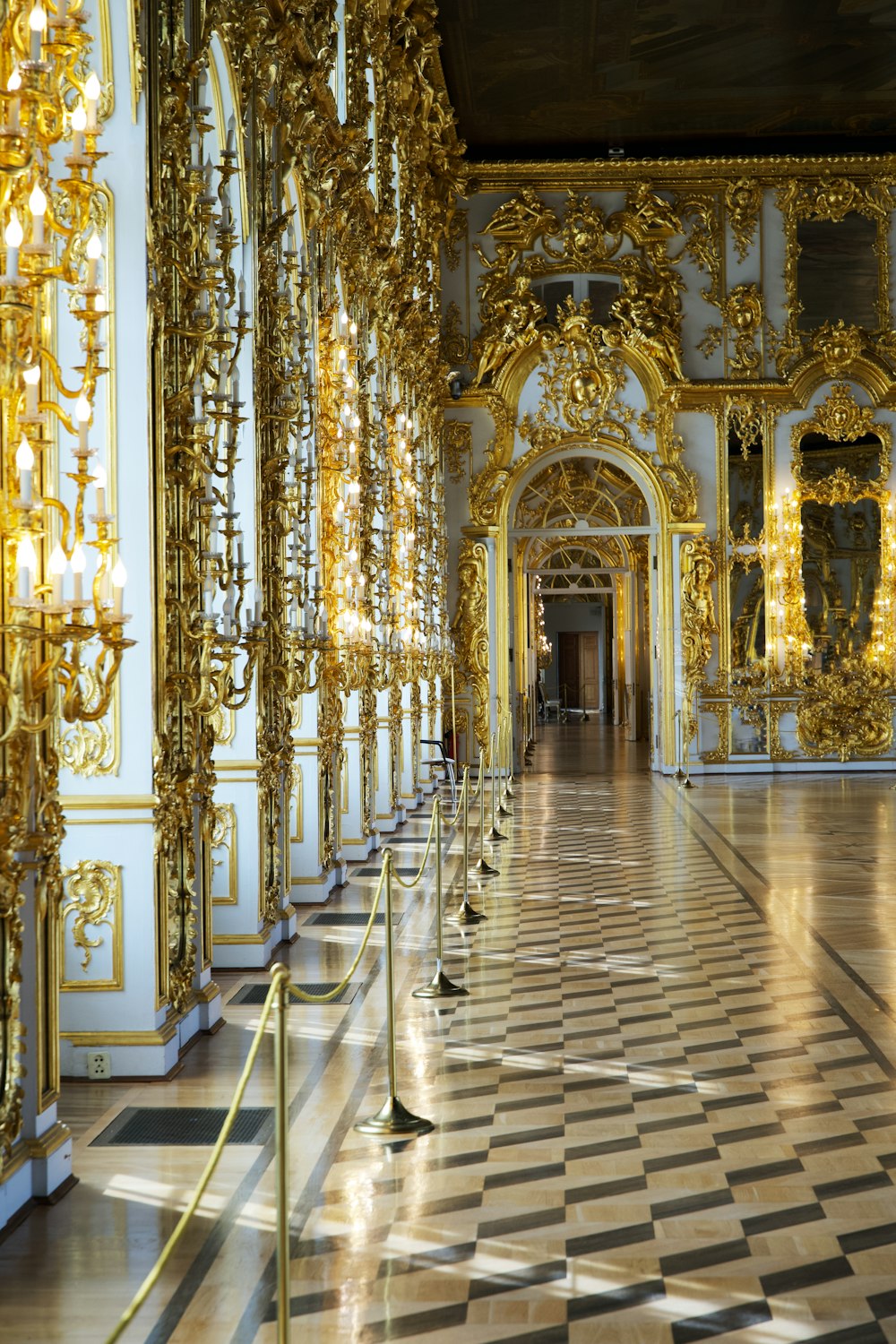 a hallway in a palace with gold decorations