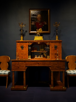 Elegant office desk made from natural wood with smooth finish and subtle gold hardware.